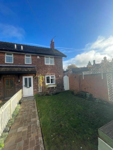 a house with a lawn in front of it at Fitzherbert Cottage in Swynnerton