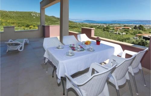 a white table with white chairs on a balcony at Amazing Home In Kastel Stafilic in Plano