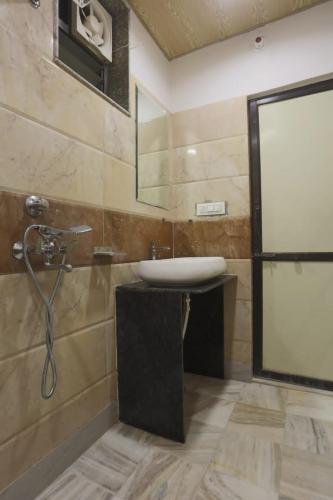 a bathroom with a sink and a shower at Holiday Out Hotel in Jodhpur