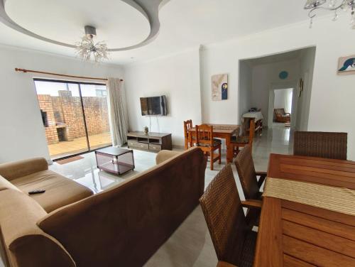 a living room with a couch and a table at Masingita Guest House in Graskop