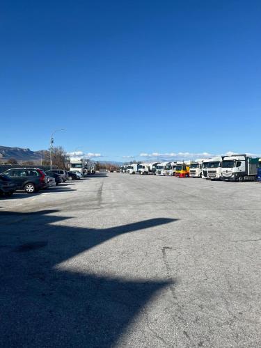 a parking lot with a bunch of parked buses at Hotel Restaurante Dama de Baza in Baza