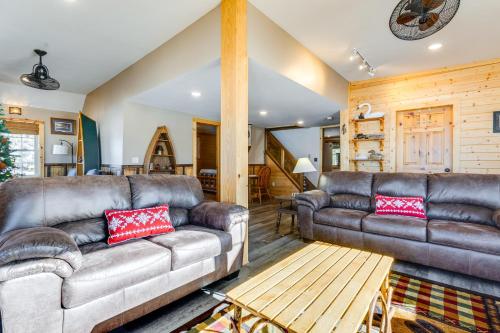 a living room with two leather couches and a table at Lakefront Cabin with Shared Beach in Cecil! in Shawano