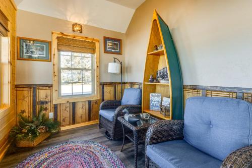a living room with a surfboard on the wall at Lakefront Cabin with Shared Beach in Cecil! in Shawano