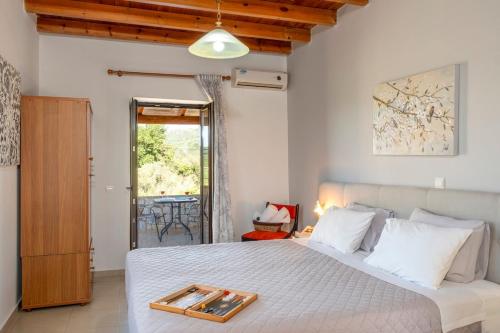 a bedroom with a bed with a tray on it at Villa Kamaraki in Patellárion