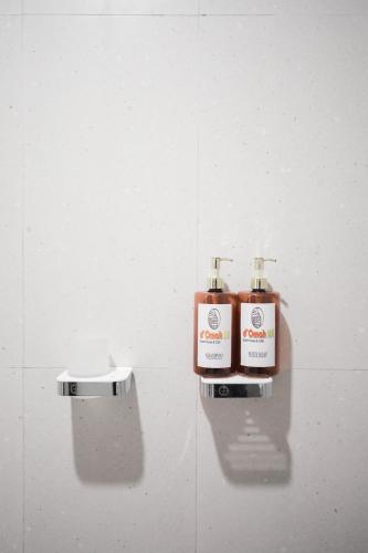 two bottles ofodorizers are sitting on a wall at d' Omah Afi 1 in Jarakan
