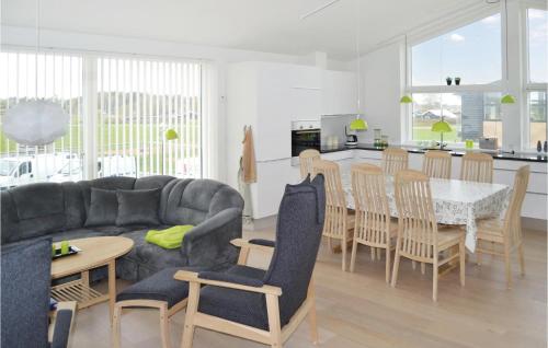 a living room and kitchen with a couch and a table at Holiday Home Frederikshavn 41 in Frederikshavn