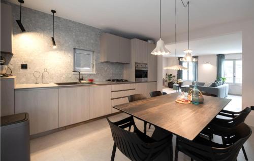 a kitchen and dining room with a wooden table and chairs at 4 Bedroom Gorgeous Home In Korcula in Korčula