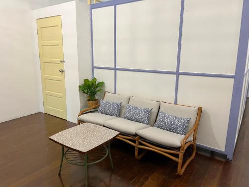 a living room with a couch and a table at Kaba Home Melaka in Melaka