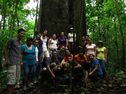 a group of people posing in front of a tree at Vocaré Finca Agroecológica in Upala