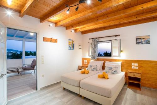 a bedroom with a bed and a balcony at Kontaratos Studios & Apartments in Parikia