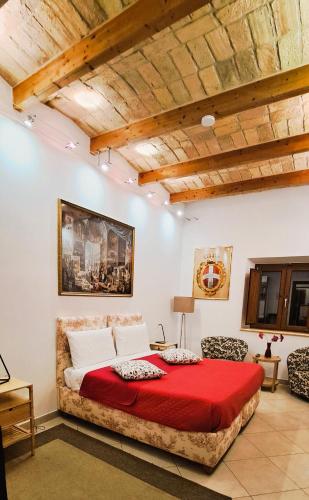 a bedroom with a large bed with a red blanket at kis inn affitacamere guesthouse in Rome