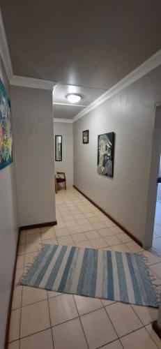 a room with a hallway with a rug on the floor at Tamboti Bush Lodge in Dinokeng Game Reserve