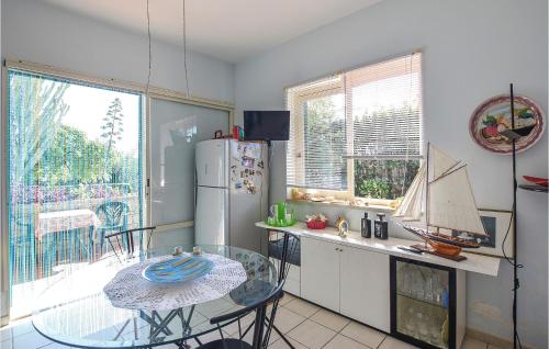 a kitchen with a table and a small table with a boat on it at Amazing Home In Marina Di Modica in Marina di Modica