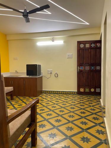 an empty room with a room with a floor with at Nathan STAY Srirangam - Uniquely Designed for a Memorable Stay in Tiruchchirāppalli
