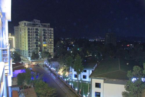 a city street at night with buildings and street lights at Nahusenay hotel in Addis Ababa