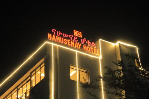 a building with a neon sign on top of it at Nahusenay hotel in Addis Ababa