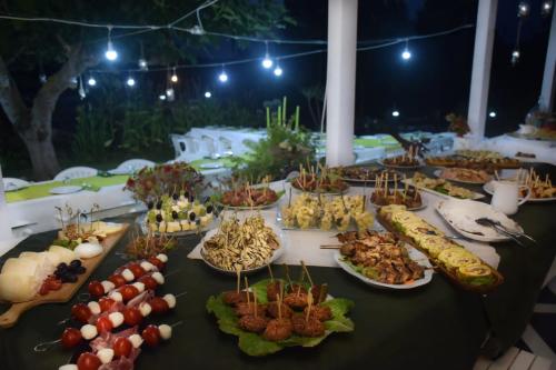 a table with many different types of food on plates at Al Passo di Thalia in Ricadi