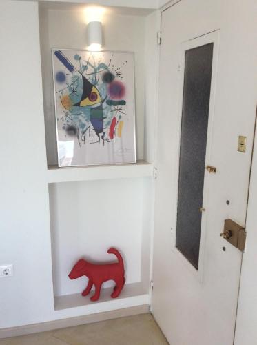 a hallway with a red dog toy next to a door at kolonaki Penthouse panoramic Acropolis view in Athens