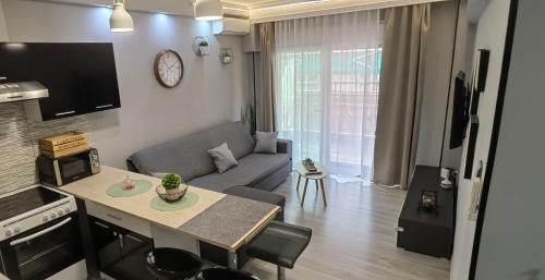 a living room with a couch and a table at Seagull center kavala in Kavala