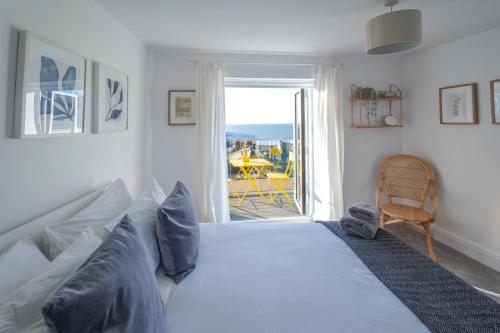 a bedroom with a bed with a view of the ocean at Bright & beautiful 4 bedroom house with sea views in Portland