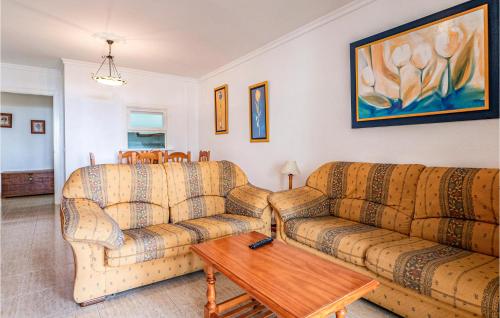 a living room with two couches and a coffee table at Cozy Apartement In Almerimar in El Ejido