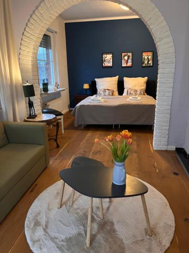 a bedroom with a bed and a table and a couch at Ferienwohnung Waldseite in Bad Bentheim