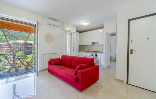 a red couch in a living room with a kitchen at Stunning Apartment In Recco With Wifi in Recco