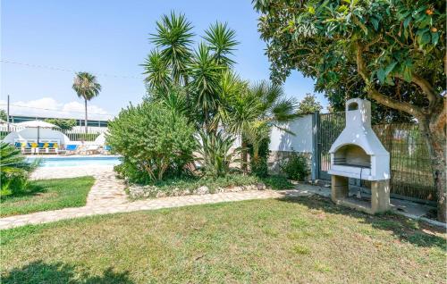 a backyard with a play implement in the yard at 2 Bedroom Cozy Home In Sabaudia in Sabaudia