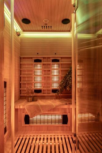 a room with a sauna with a bed and windows at Kuiseb House in Windhoek