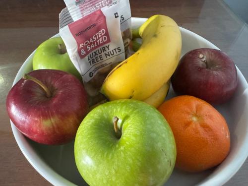 a bowl of fruit with apples oranges and bananas at Boutique by Beach Collection in Strand