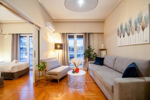 a living room with a couch and a table at The Parthenon Porch for Familys & Groups , 4BR ! in Athens