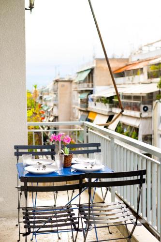 a blue table with two chairs on a balcony at The Parthenon Porch for Familys & Groups , 4BR ! in Athens