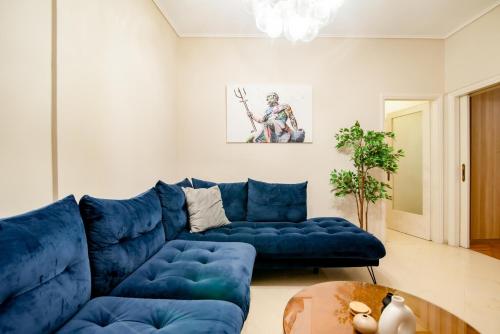 a living room with a blue couch and a table at The Parthenon Porch for Familys & Groups , 4BR ! in Athens