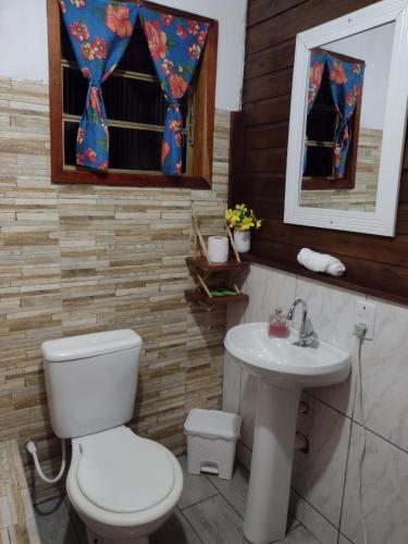 a bathroom with a toilet and a sink at Chalé Refúgio Encantado 2 in Eldorado