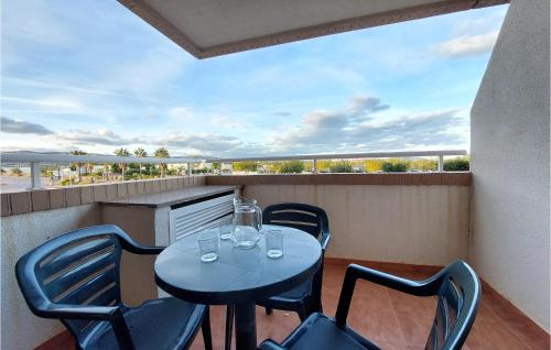 a patio with a table and chairs on a balcony at Cozy Apartment In Oropesa Del Mar in Oropesa del Mar