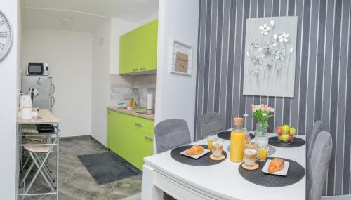 a kitchen with a table with food on it at Apartman Nika in Vukovar