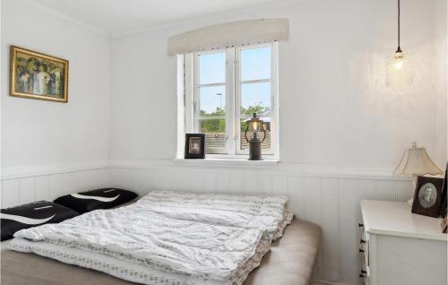 a white bedroom with a bed and a window at Stunning Home In Ålbæk With Kitchen in Ålbæk