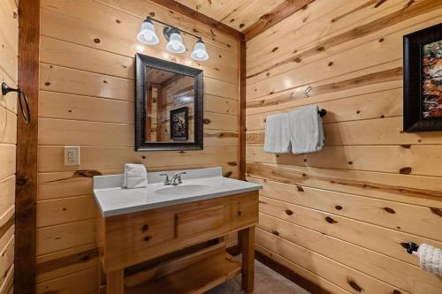 a bathroom with a sink and a mirror at NewListing! Mtn View, Pvt Heated Pool, Theater, GameRoom, BBQ, Hot Tub, 6 bedroom with attached Bath, Sleeps-12 in Sevierville