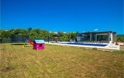 a backyard with a pool and a playground with a house at Gorgeous Home In Grubine in Grubine
