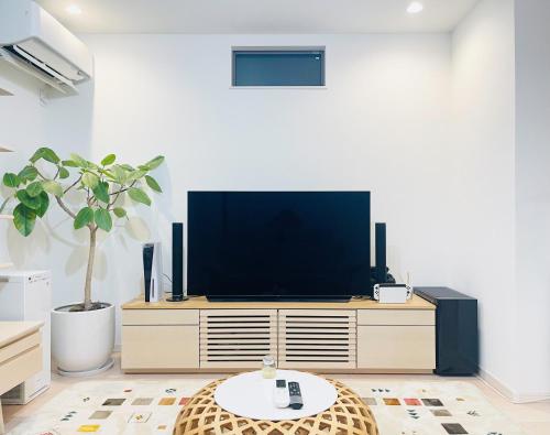 a living room with a tv on a dresser at Alo BnB 7 - Near IKEBUKURO, SHINJUKU, UENO - Self Check in - OYAMA Sta 3min in Tokyo