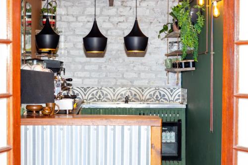 a kitchen with a counter and pendant lights at The Forest Dome Tsitsikamma in Stormsriviermond