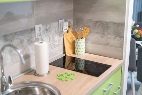 a small kitchen with a counter top with a sink at Apartman Nika in Vukovar