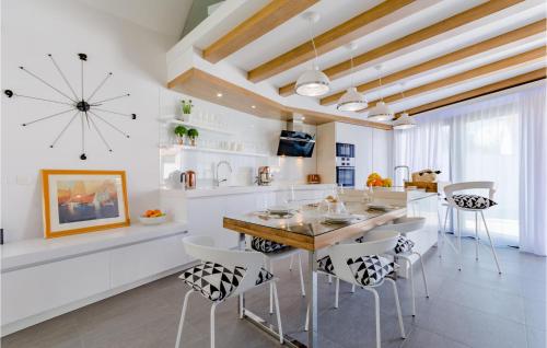 a kitchen with a large clock on the wall at Beautiful Home In Sutivan With Wifi in Sutivan