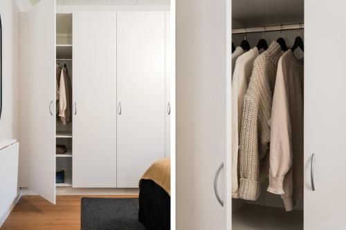 a bedroom with white cabinets and a closet at Guestly Homes - 1BR Scandinavian Charm in Piteå