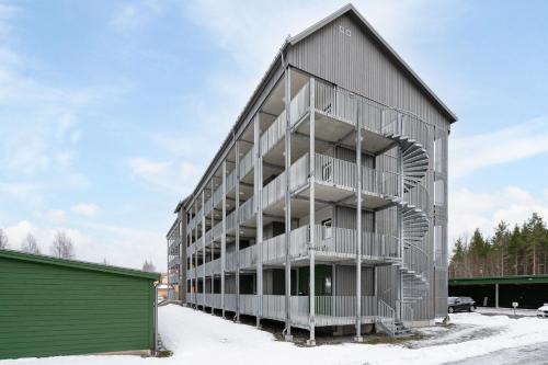 an apartment building with balconies on the side of it at Guestly Homes - 1BR Scandinavian Charm in Piteå