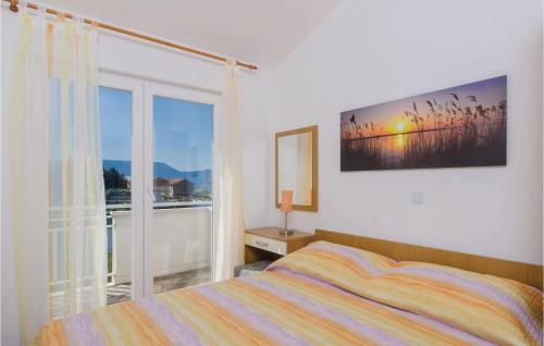 a bedroom with a bed and a large window at Apartment Blace With Sea View Xiii in Blace