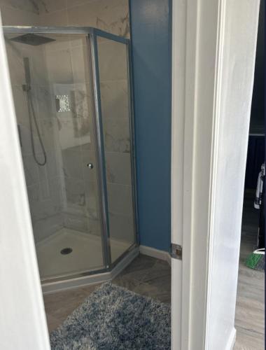 a shower with a glass door in a bathroom at Keri APRN LLC in Ansonia