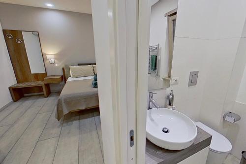 a bathroom with a sink and a bed in a room at Museo19 in Naples