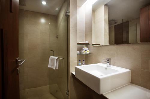 a bathroom with a sink and a shower at d'primahotel Seminyak in Seminyak