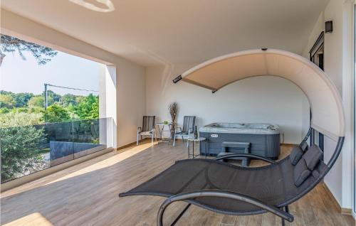 a room with a large window and a chair at Beautiful Home In Porec With Kitchen in Poreč